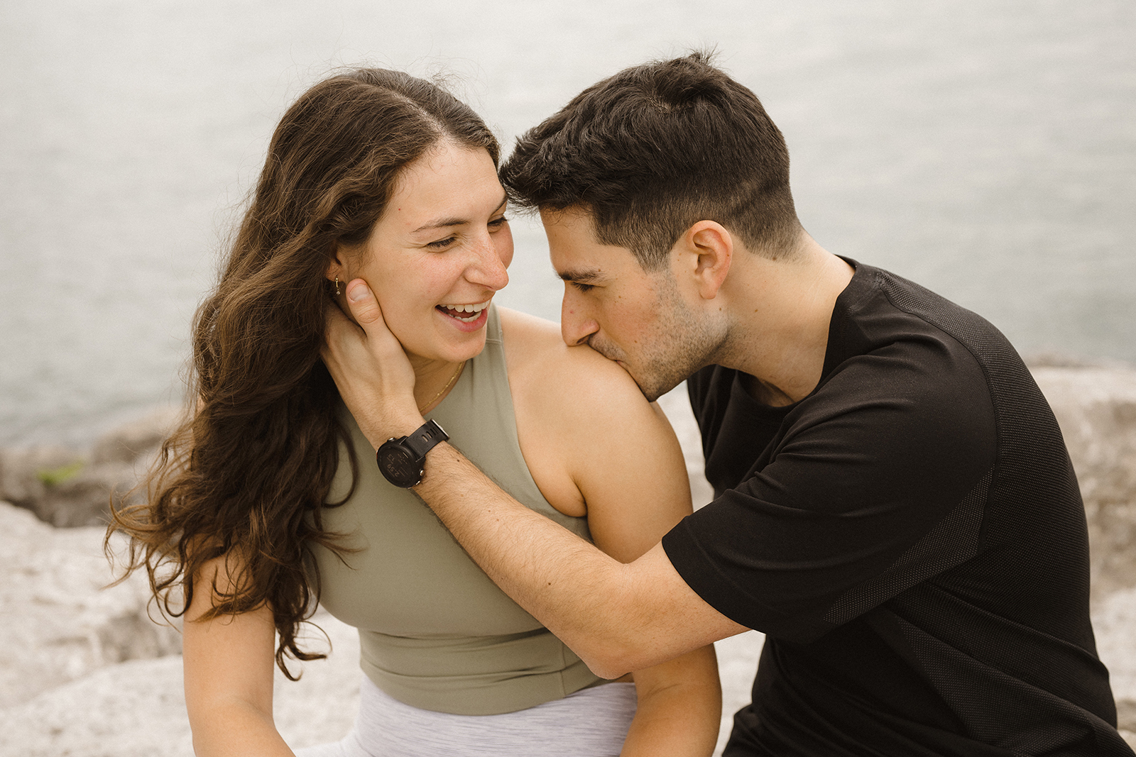 couple laugh together during photos at durham region beach